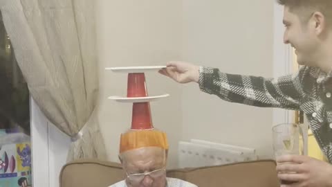 Family Plays a Game on Sleeping Grandpa