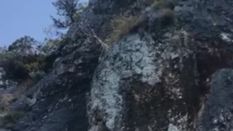 T air running big cliff jump filmed from below