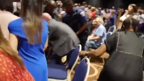 Heckler Gets Shoved To The Floor After Questioning Her About Epstein Island