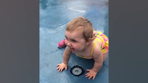 Funny baby playing with water