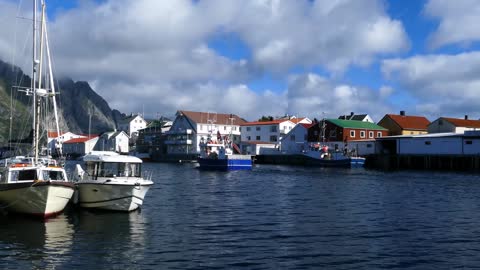 fishing boat passing by at the village henningsvaer norway