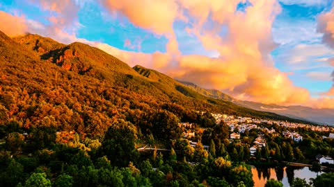 Time-lapse. The evolution of clouds on the mountainside at sunrise.