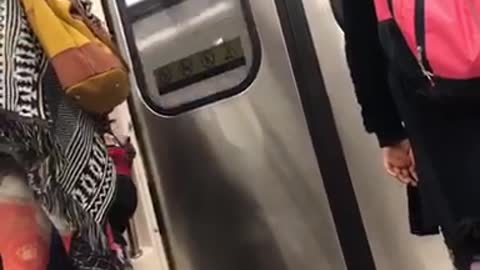 Two kids kicking each other on train