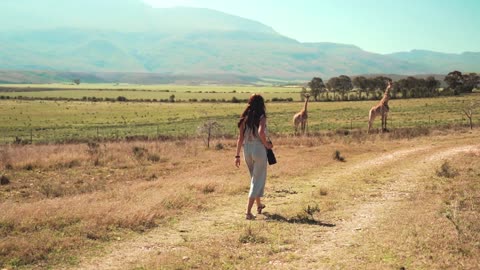 A Woman Walking while Taking Pictures