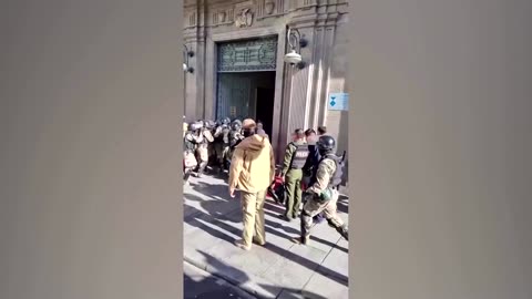 Army vehicle smashes through Bolivian palace doors