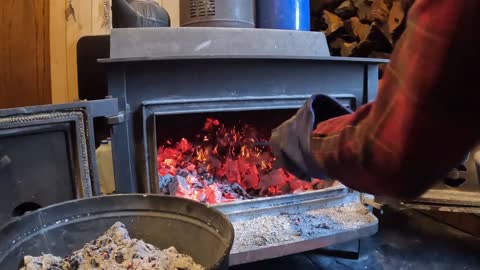 Cleaning the ashes out of Wood stove is still hot and full of coals Alaska Co Inc.