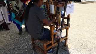 A young man making a bracelet.