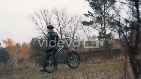 Athlete Man Resting From Riding A Mountain Bike In Countryside