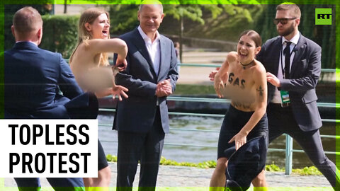 Topless activists storm Scholz event