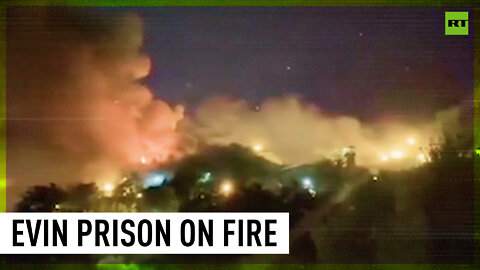 Gunshots ring out as Iranian prison burns