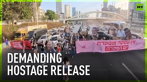 Protesters holding giant photos of Hamas hostages block Tel Aviv's Ayalon Highway