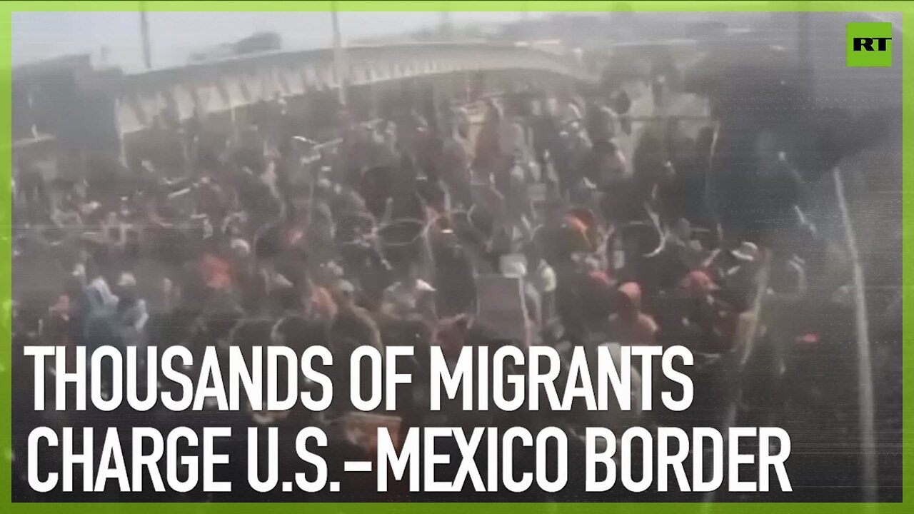 Thousands of migrants charge U.S.-Mexico border