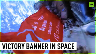 Russian cosmonauts unfold replica of Victory Banner in open space