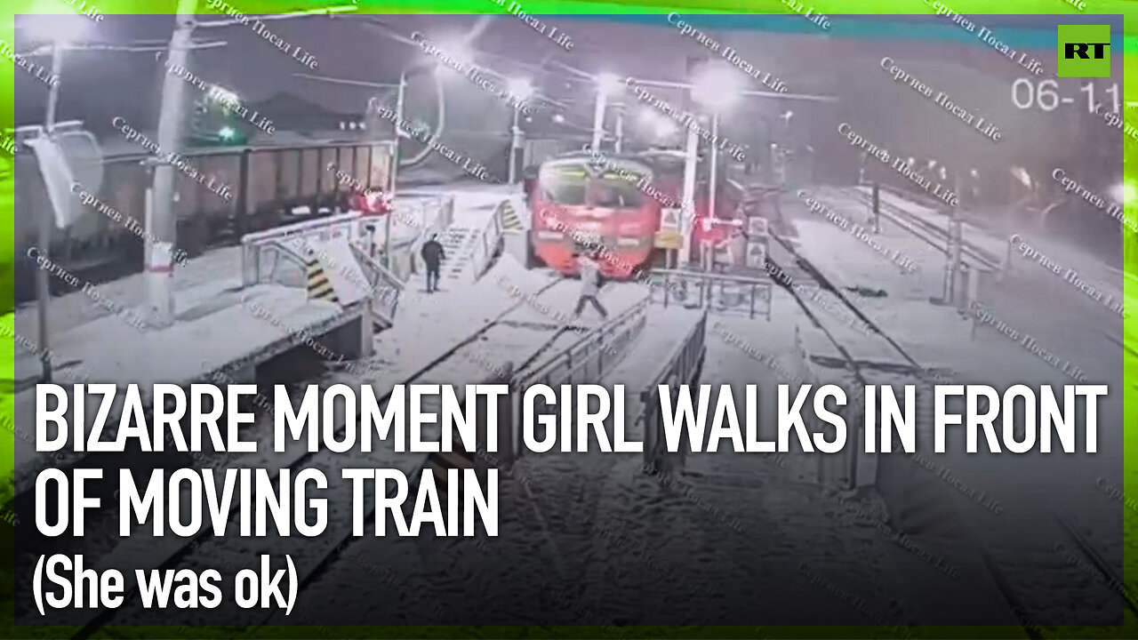 Bizarre moment girl walks in front of moving train