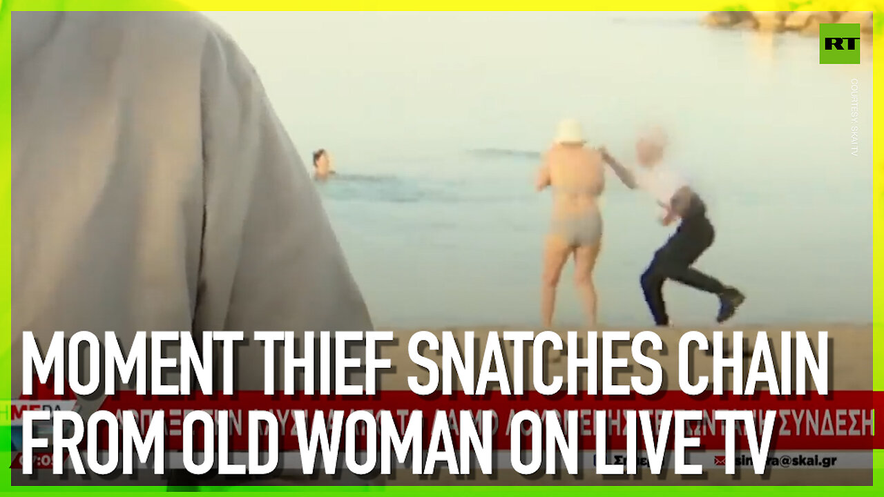 Moment thief snatches chain from old woman on TV