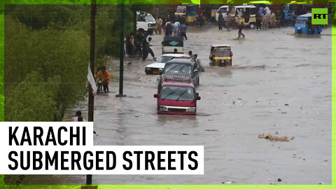 Karachi floods force people to push vehicles through streets