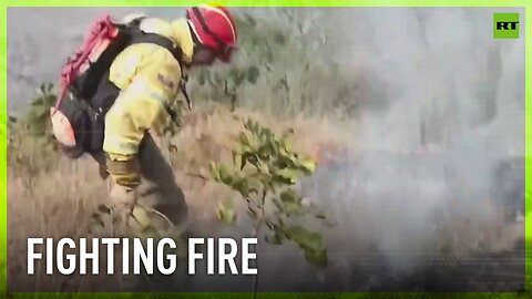 Firefighters battle with massive wildfire in Ecuador