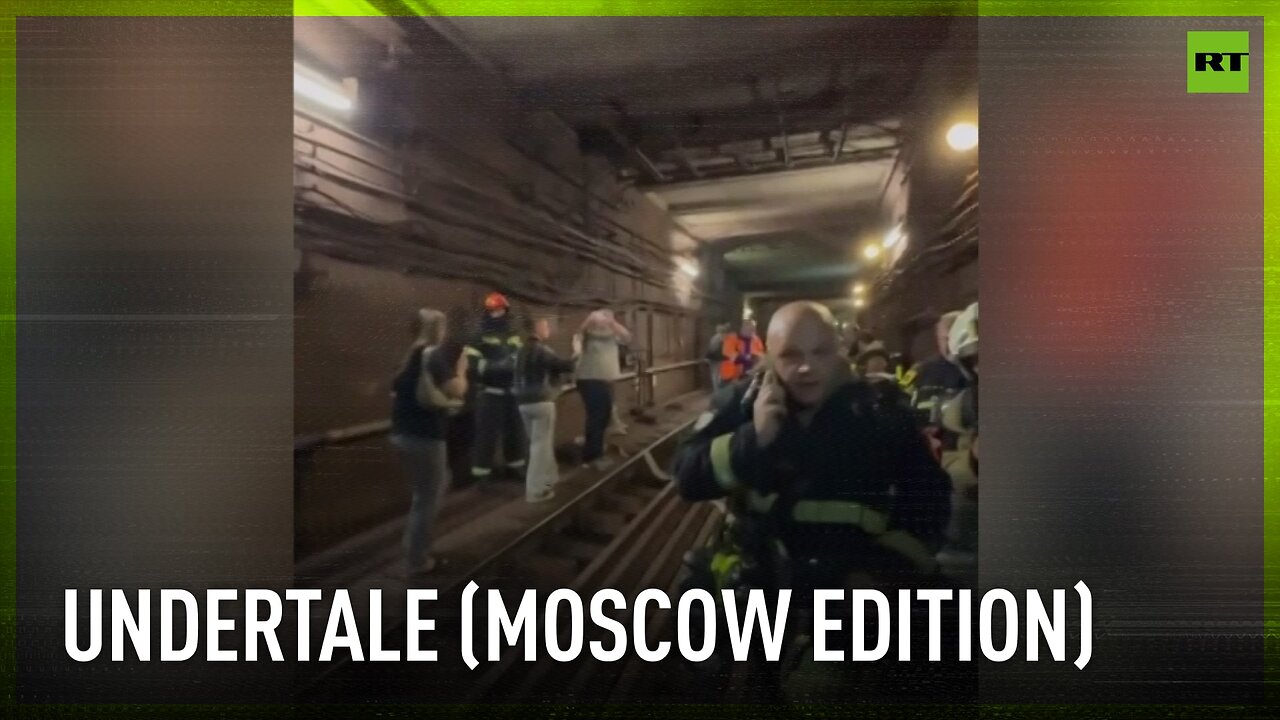 Passengers walk trough Moscow metro tunnel