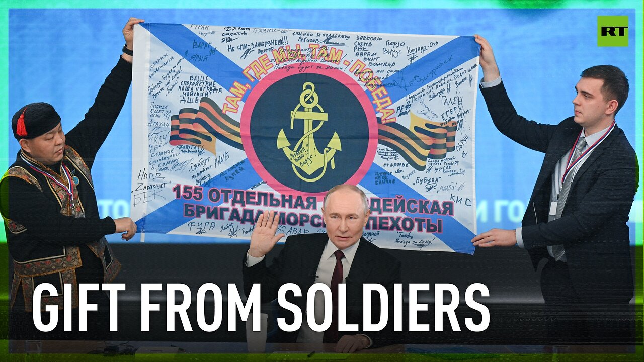 'Soldiers pass souvenirs to me': Putin shows a combat banner gifted to him by Russian marines