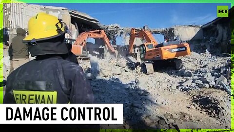 Firemen & excavators clear the site hit by missiles in Iraq's Erbil