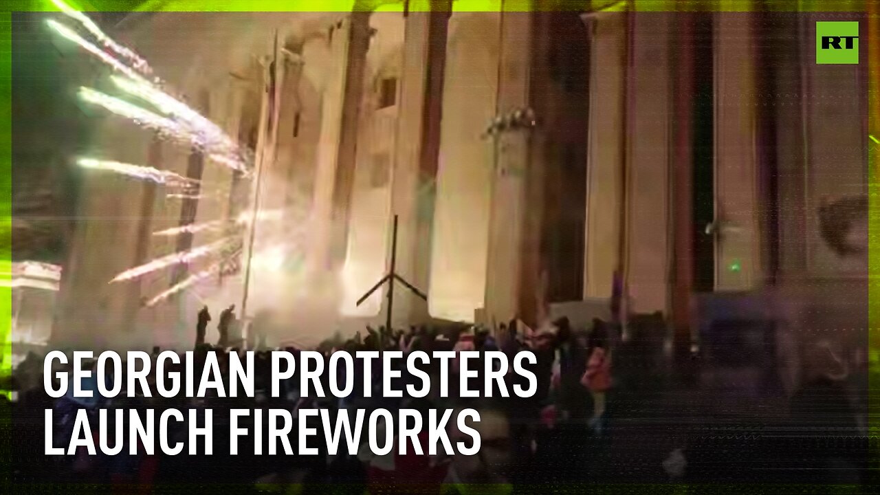 Georgian Parliament building lit up with fireworks set off by pro-EU protesters