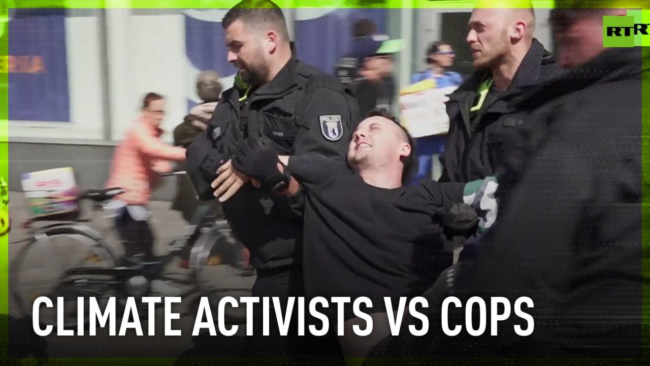 Police drag climate protesters off busy street in Berlin