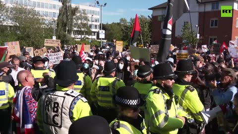 Protesters rally against anti-immigration activists near hotel housing migrants in UK