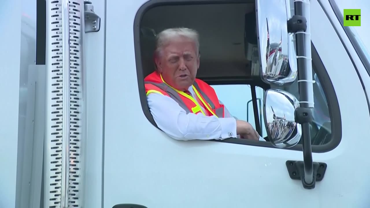 Trump talks to press from a garbage truck