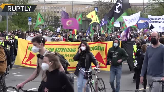 Protesters scuffle with officers as thousands join left-wing march against police racism in Berlin