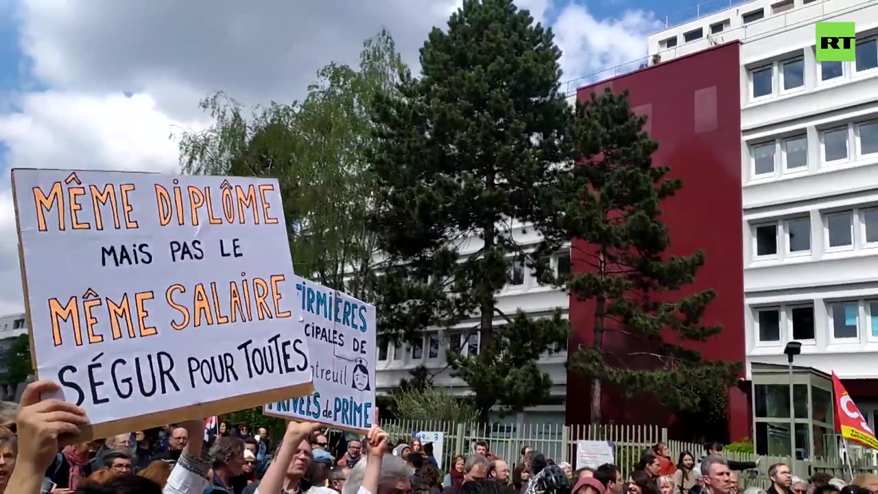 Protesters clash with police as health minister visits Paris suburb