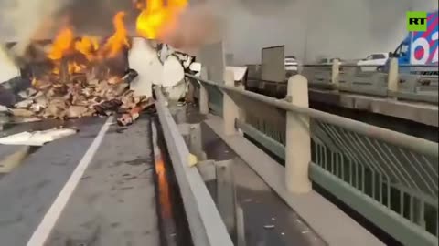 Driver killed as burning cargo truck falls from bridge in Russia