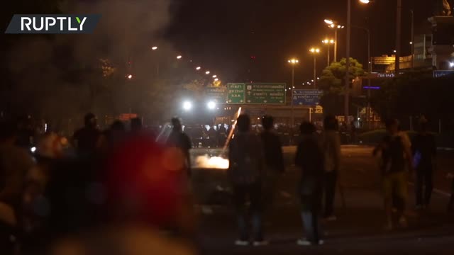 Anti-govt protesters and Bangkok police exchange fireworks and tear gas