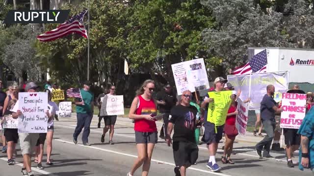 Florida protesters burn face masks during rally against COVID measures