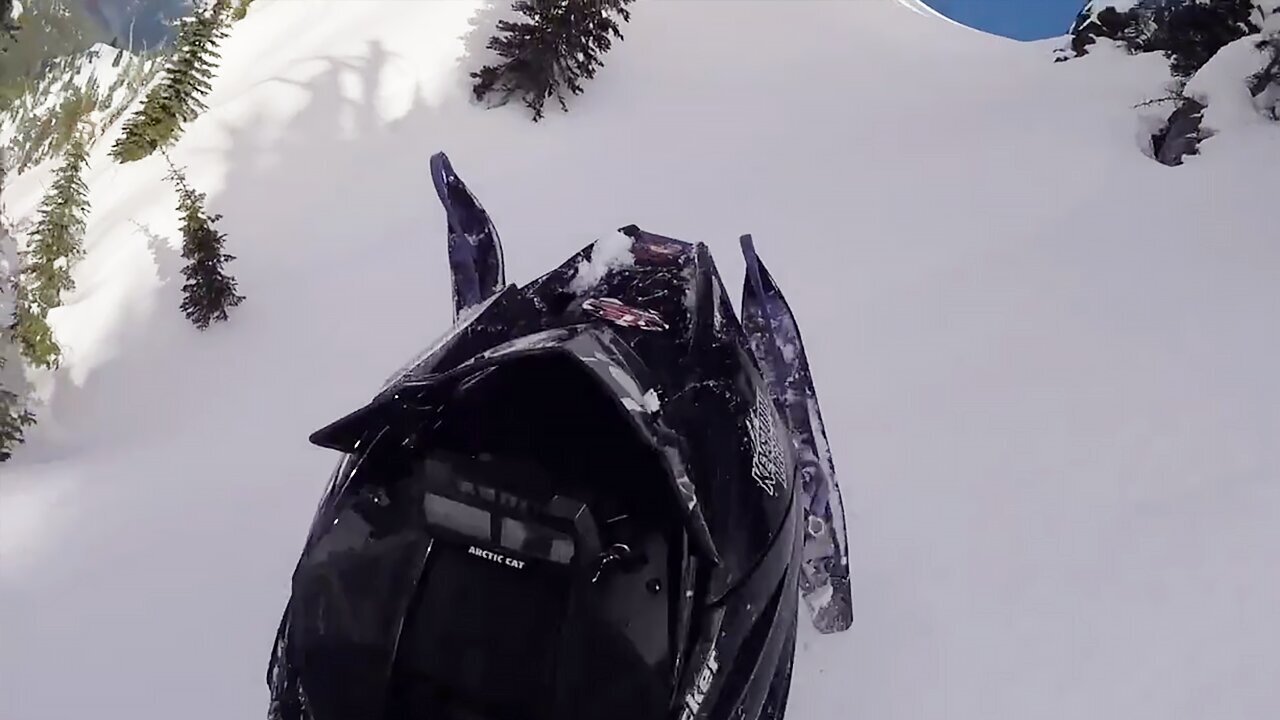 Dude tries to snowmobile up mountain, instantly regrets it