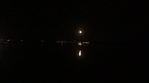 Full Moons Reflection Rising Over The Horizon