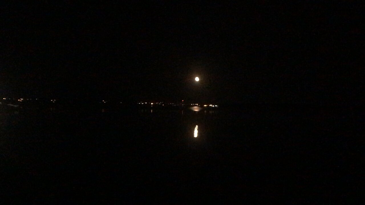 Full Moons Reflection Rising Over The Horizon