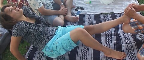 Luodong Massages Cute Woman In Aqua Shorts At The Park