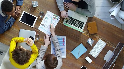 top view of four business people sitting at modern office desk and discussing work SBV 338002682 HD