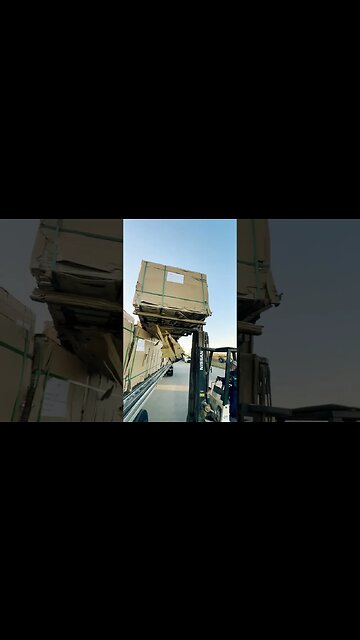 Unloading bundles of plywood early in the morning