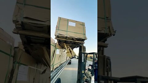 Unloading bundles of plywood early in the morning