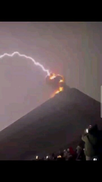 Nature: Violent lightning storm during a volcano eruption.