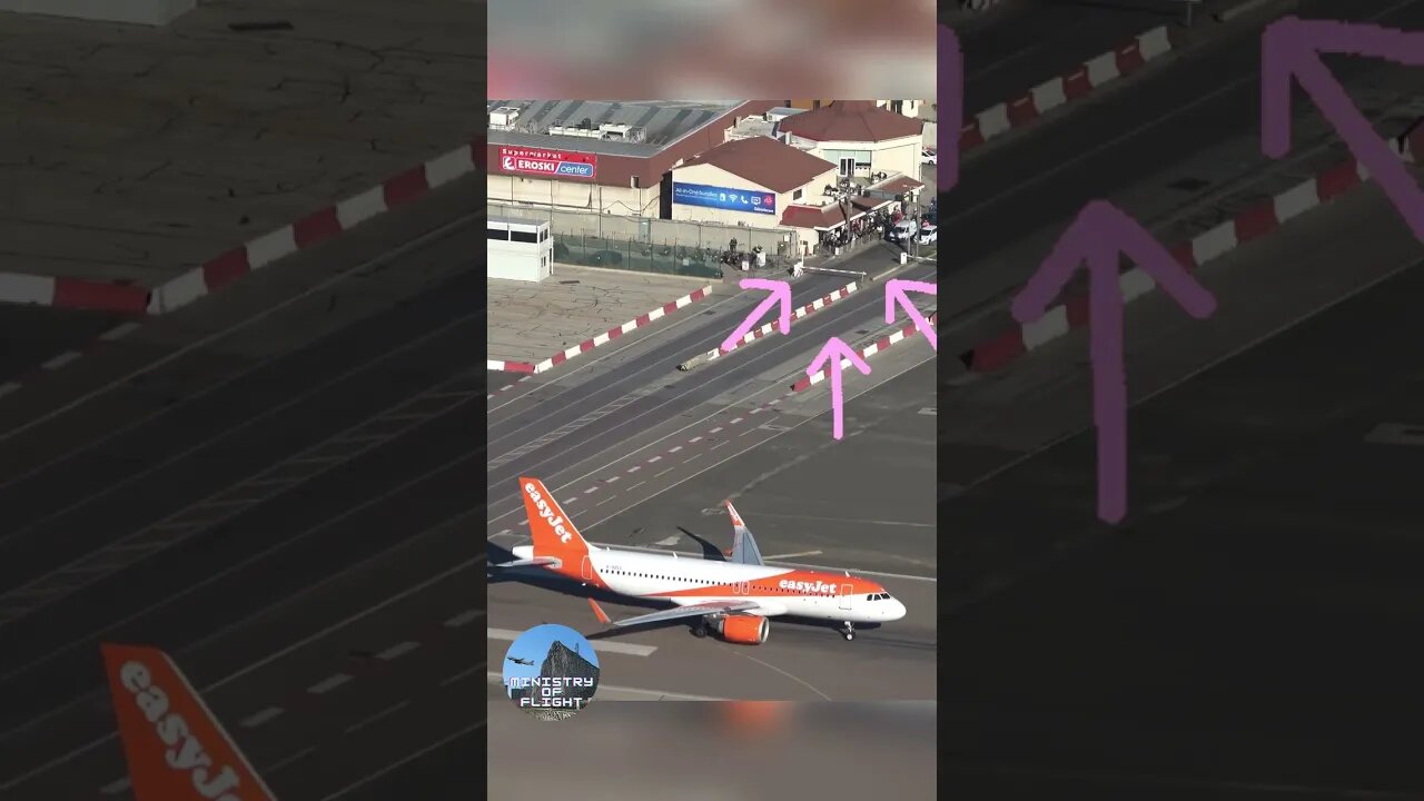 Plane Taxis on Runway as Cars wait to Cross at Gibraltar Airport