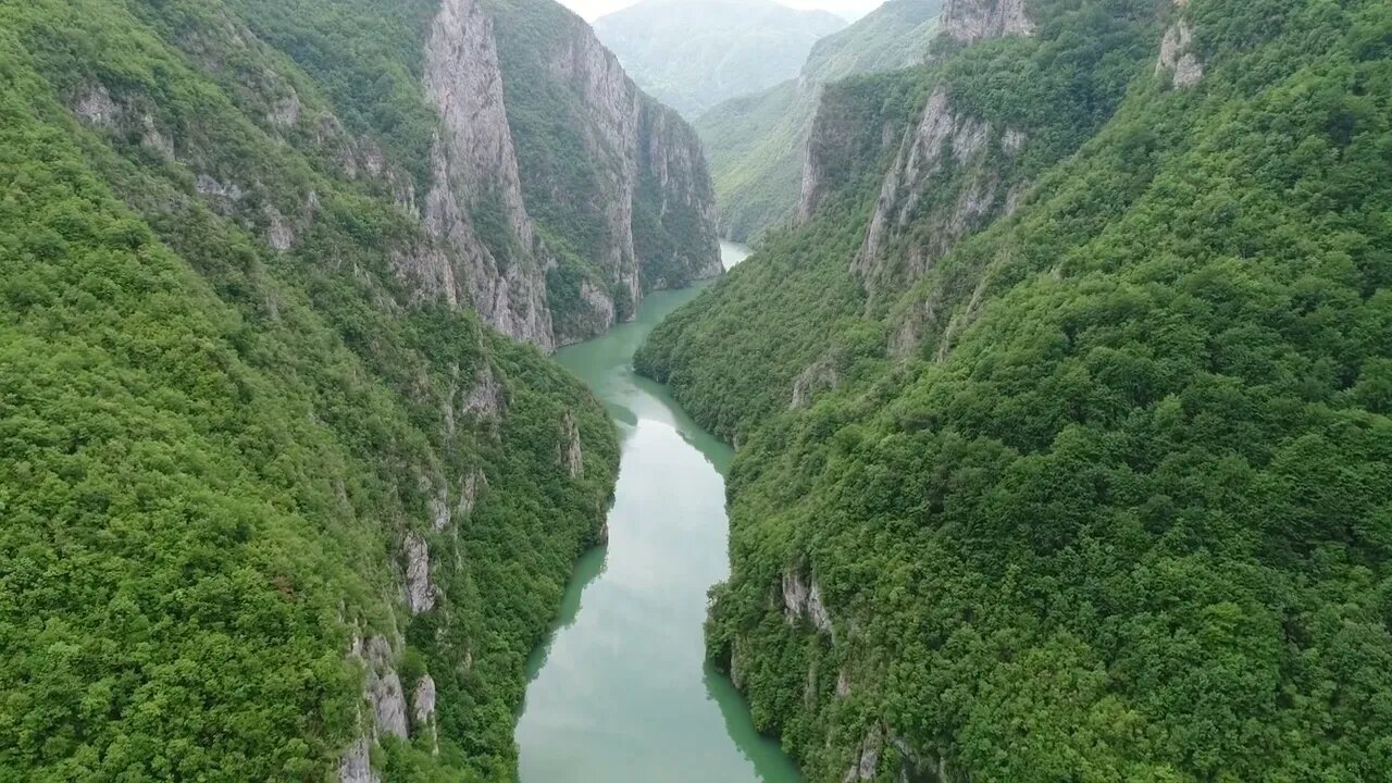 aerial and moving footage through a canyon with beautiful nature and a river below SBV 330788679 HD