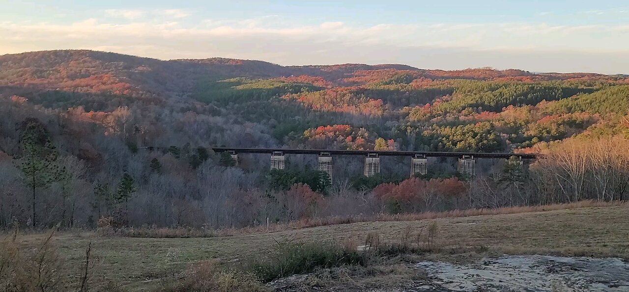 Train on trestle with Colorful Fall Mountain Foliage in Background