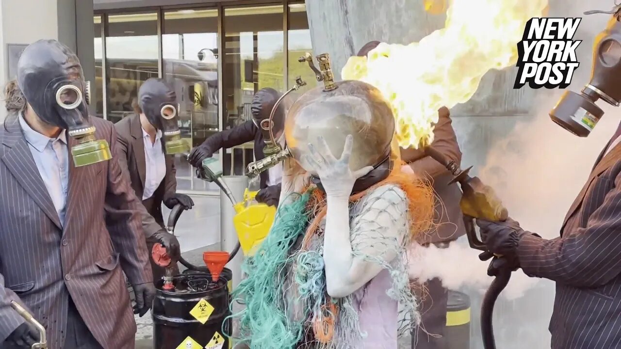 Climate change activists ‘drown’ themselves with oil, gas and flames in nightmarish protest