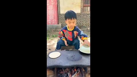 Chinese boy making burger