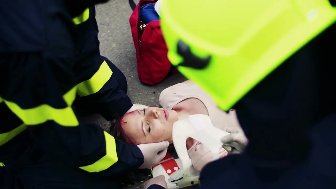 unrecognizable firefighters rescuing a young injured woman lying on the road after SBV 326041260 HD