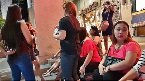 Philippines street prostitutes outside shopping mall waiting for customers.