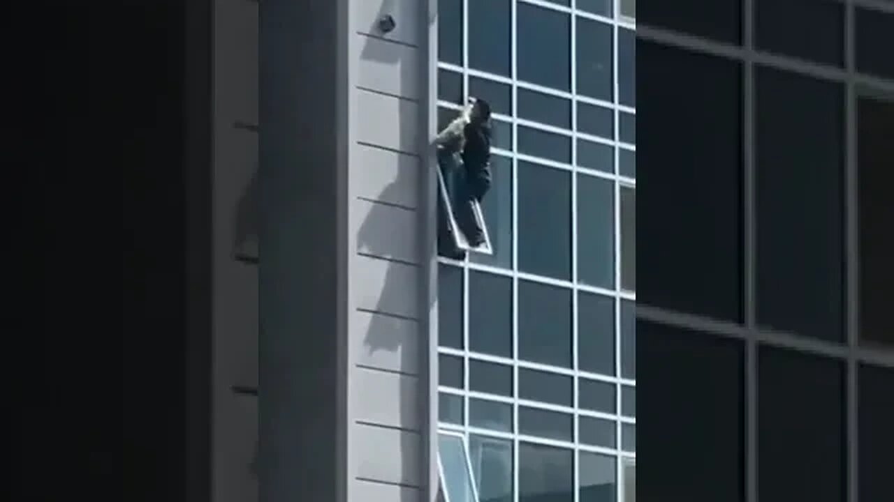 Guy climbs apartment to save a girl from falling