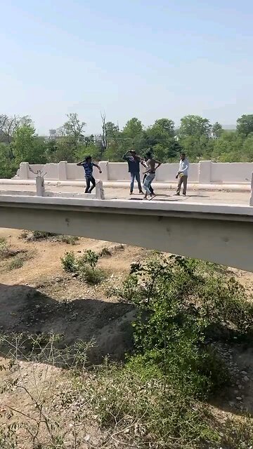 Fight result in man getting thrown off bridge. He survived hurt but alive.